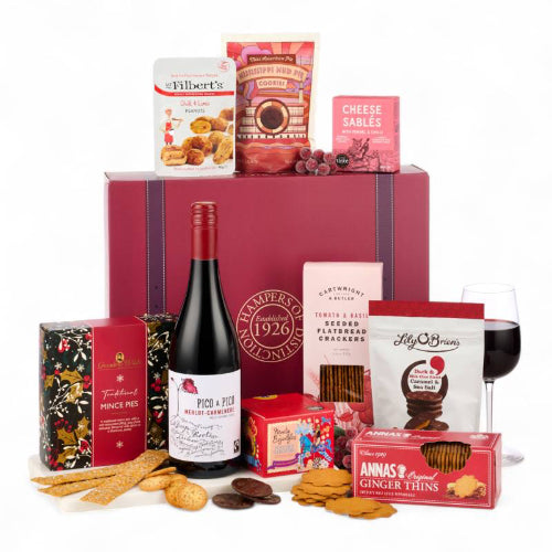 Luxury festive hamper filled with Christmas treats, wine, and family sharing snacks.