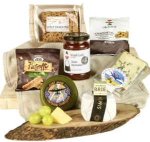 Elegant food gift box with fine cheese, crackers, and gourmet nibbles