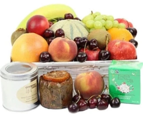 Luxury gift basket with tea, fruit cake, and assorted fresh fruits
