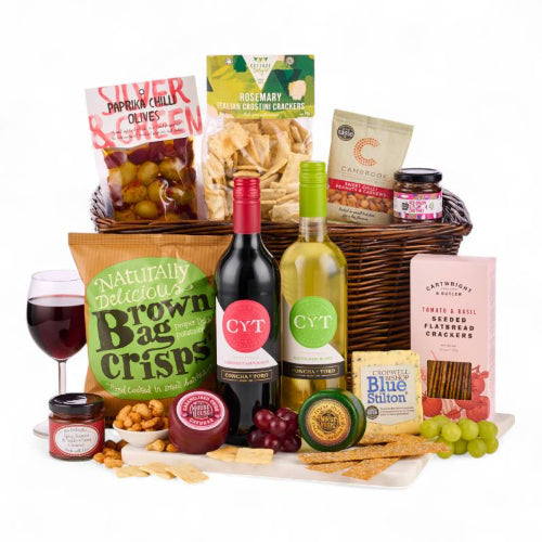 Elegant wicker tray filled with gourmet cheese, wine, and snacks gift set