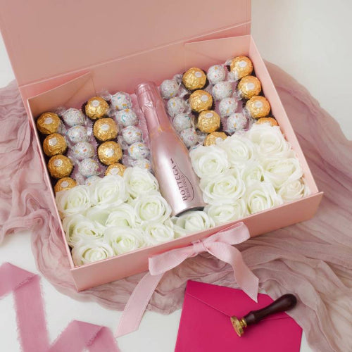 Elegant Pink Prosecco gift set featuring white roses and luxury chocolates Gift box with flowers, and chocolates