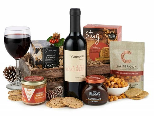 Celebration gift basket with red wine, gourmet pâté, and savoury treats
