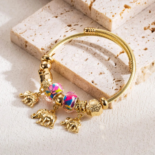 Gold bracelet with colorful charm 