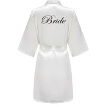 Load image into Gallery viewer, White satin robe with &#39;Bride&#39; text Bridesmaids in matching satin robes getting ready for wedding