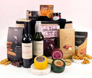 Luxury British hamper basket with cheese, wine, and holiday nibbles
