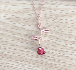 Gold and silver rose necklace with a vibrant red flower charm, designed as a meaningful gift for her.