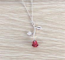 Load image into Gallery viewer, A silver necklace featuring a detailed red rose pendant, styled for women.