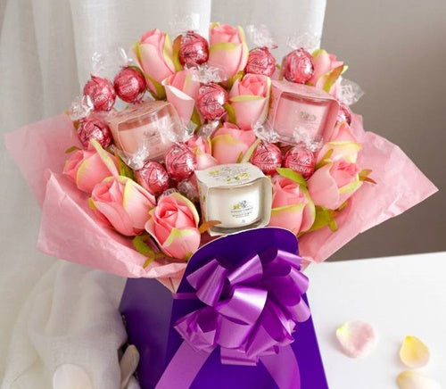 Luxury bouquet gift with Yankee Candle, roses, and Pink Lindor chocolates in hat box