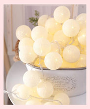 Load image into Gallery viewer, Cotton ball fairy lights creating a warm romantic ambiance