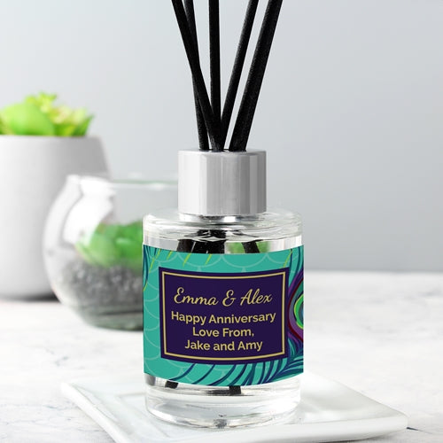 Elegant peacock-themed reed diffuser with custom name label and natural reeds, beautifully packaged for gifting.