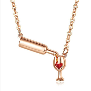 Whimsical charm necklace with wine bottle, wine glass, and red heart detail, ideal for wine lovers.